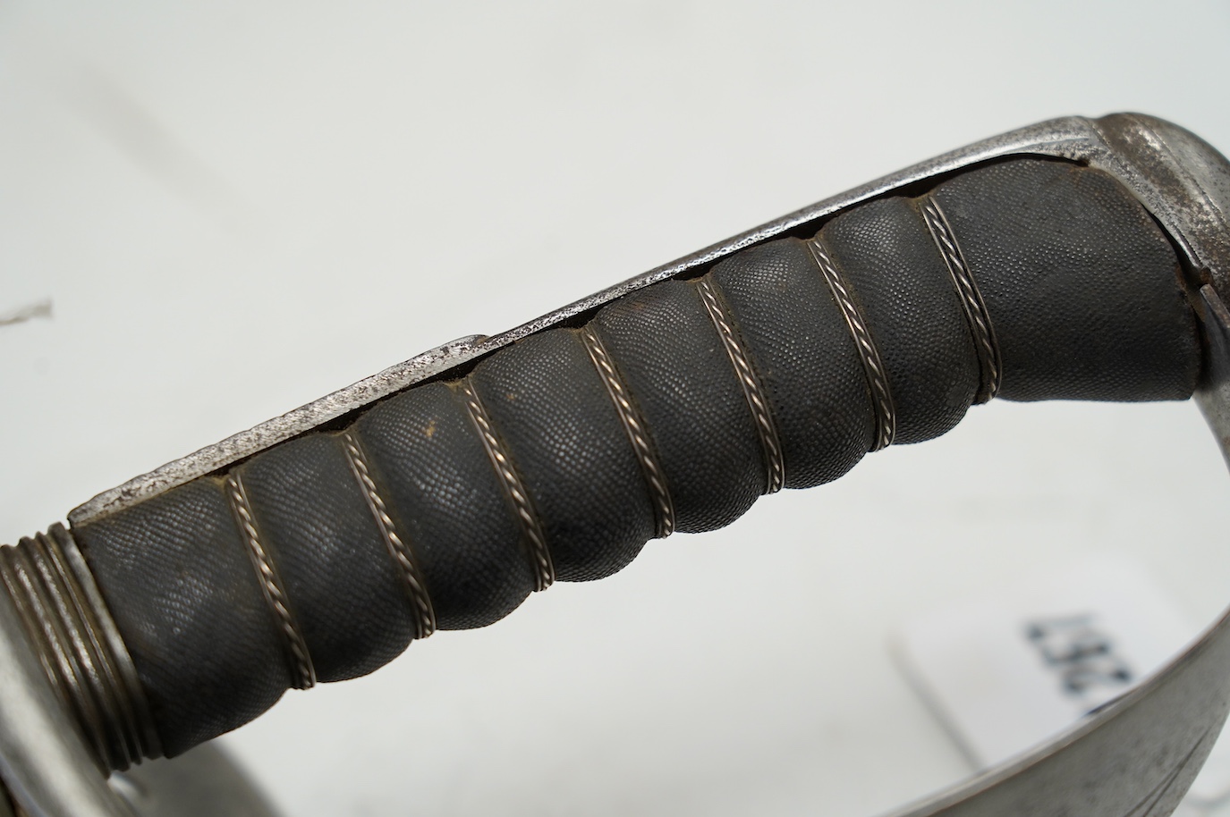 An 1898 pattern British NCO’s sword with leather scabbard, Edward VII cipher to guard, the blade with government stamps, issued 1903, blade 82cm. Condition - fair, some wear overall